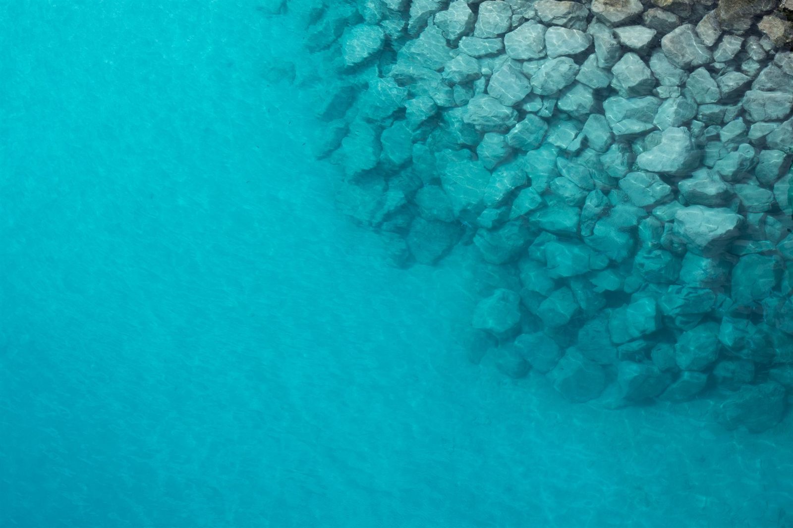 Aerial view of a rocky shoreline in the clear water of Bimini, Bahamas