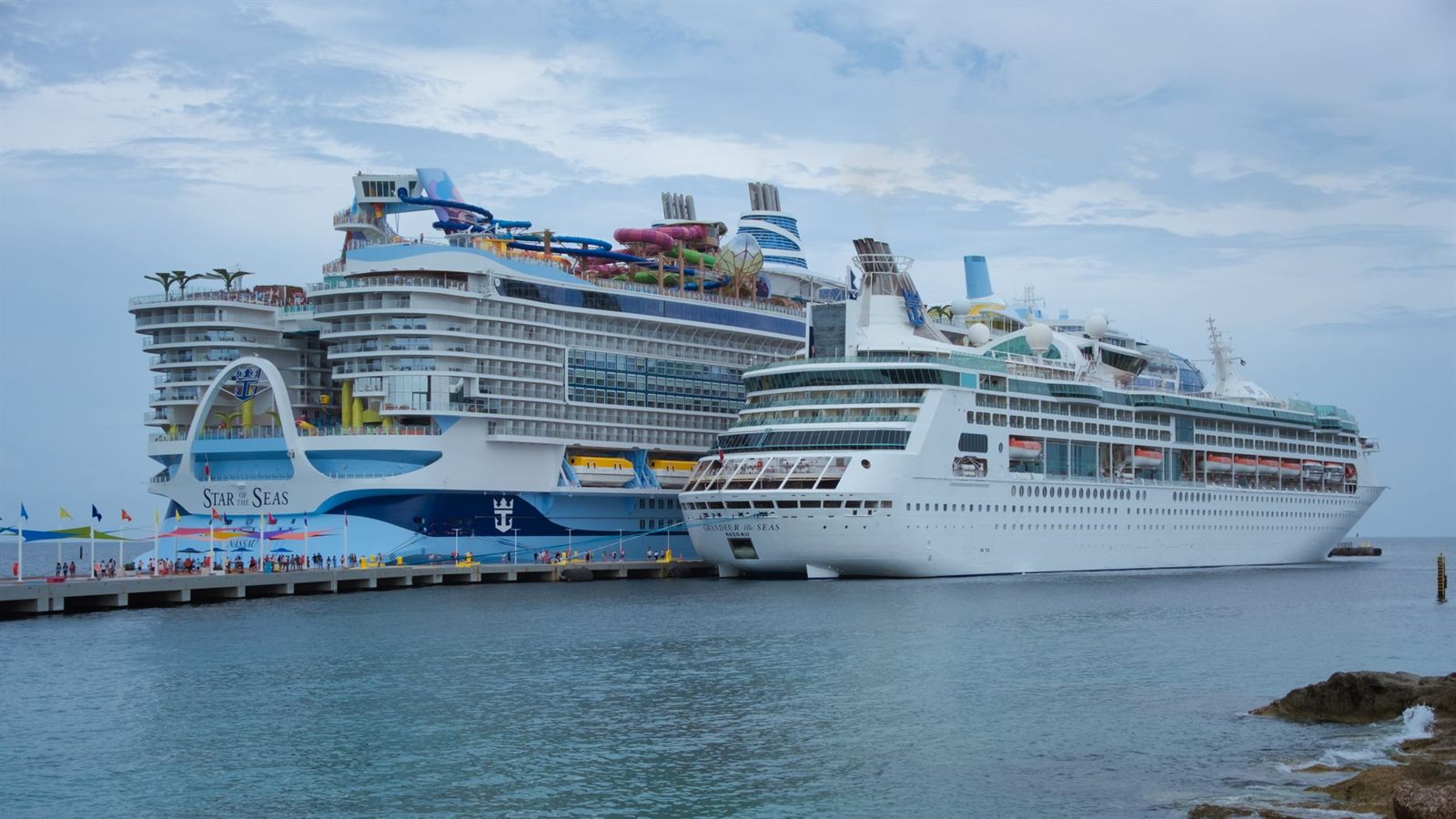 Two cruise ships docked at a pier in the Bahamas
